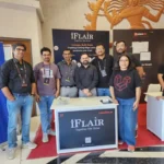 iFlair team members posing together in front of their booth at Laracon India 2025