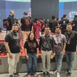 iFlair team members standing together inside the Laracon India 2025 venue